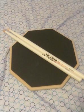 Double sided drum pad and sticks