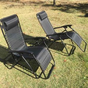 Two Zero Gravity Chairs With Side Tables