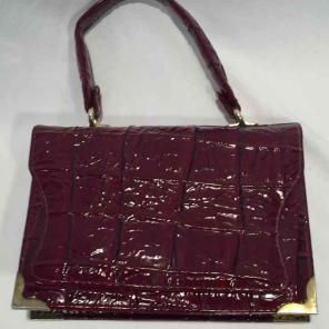 Leatohandbag read with alligator pattern