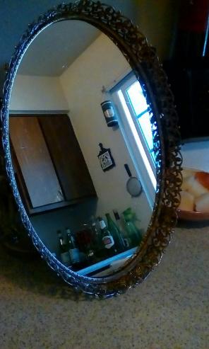 Oval brass mirror