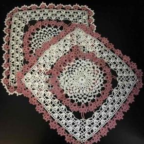 Two vintage square pink & white doilies
