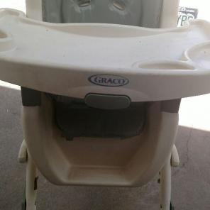 Green and white highchair for sale.