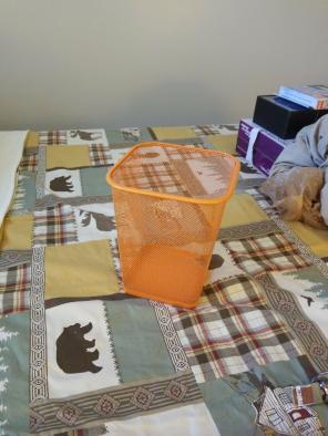 Orange metal mesh trashcan