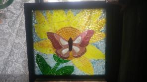 Mosaic butterfly made on old window