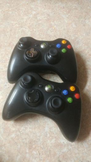 Two (2)black xbox 360 gaming controllers