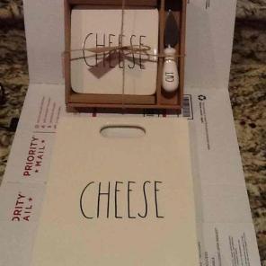 Rae Dunn cheese board and cheese cut