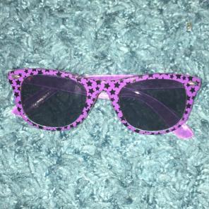 Purple sunglasses with black stars
