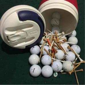 Igloo cooler with golf balls and tees.