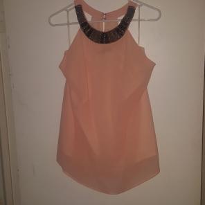 Sleeveless blouse w/embellished neckline