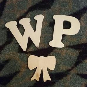 Unpainted wooden letters and bow