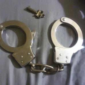 Police hand cuffs with key