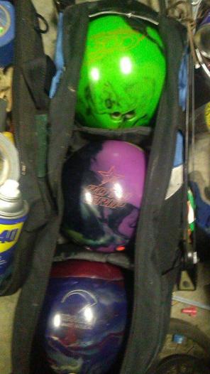 Three bowling balls and bag