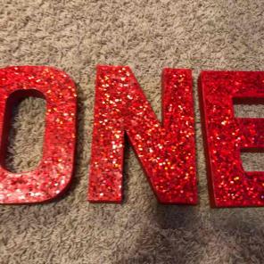 Red sparkly "one" letters