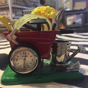 Desk clock garden tools in wheelbarrow