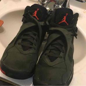 Green and black air jordan shoes.