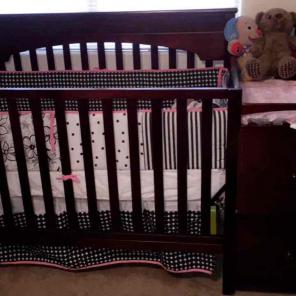 Brown wooden crib .