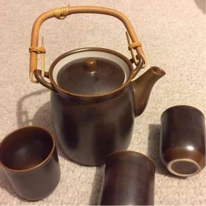 Brown ceramic teapot with matching cups