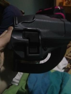 Hard plastic holster with push-button re