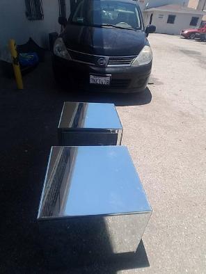 Two clear glass side tables