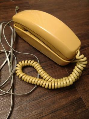 Vintage yellow rotary dial phone