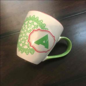 A initial pink and white and green mug