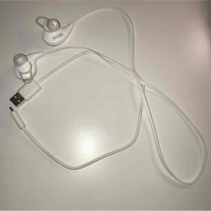 White Bluetooth headphones with charger