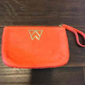 Kelly Wynne leather orange wristlet