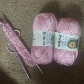 soft pink yarn & knitting needles